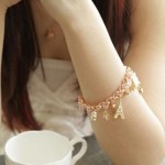 Arihant Gold Plated Pink and White Eiffel theme Charm Bracelet