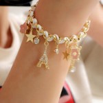 Arihant Gold Plated White and Pink Eiffel theme Charm Bracelet
