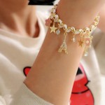 Arihant Gold Plated White and Pink Eiffel theme Charm Bracelet